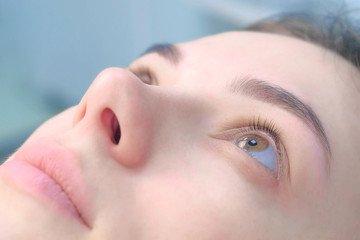 Woman's lashes before beauty procedure of eyelash lifting and laminating, closeup face view. Young woman in cosmetology clinic. Lift of lashes and eyelashes.