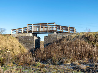 landscape with wooden bridge over the ditch