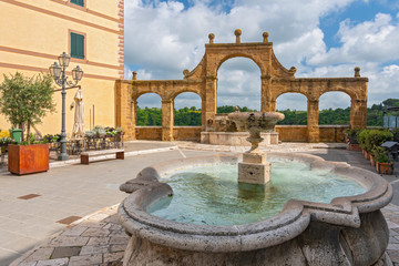 Ancient Fountain and arches in Repubblica square in Pitigliano, Italy.
