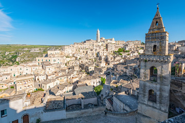 Obraz premium View of the ancient town and historical center called Sassi, perched on rocks on top of hill, Matera, Basilicata, Italy.