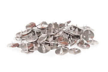 Heap of metal push pins on white background