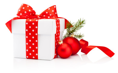 White gift box tied red polka dot ribbon and Christmas baubles Isolated on white background