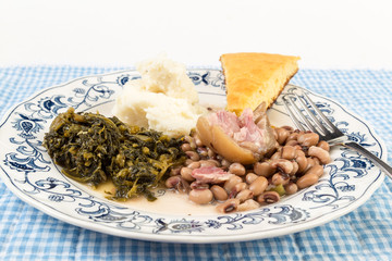 Pickled Pig Foot on Soul Food Plate with Collard Greens and Black Eyed Peas and Mashed Potatoes and Cornbread