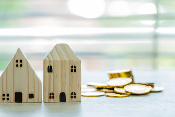 Finance business real estate investment concept, House model with stack money coins. miniature...