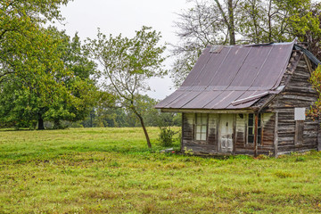   Abandoned, old house remains in a raural field.