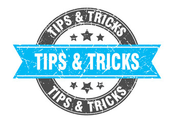Fototapeta premium tips & tricks round stamp with turquoise ribbon. tips & tricks