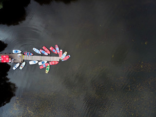 Top view of colorful boats on a black lake