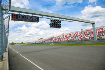 green traffic lights and circle counter on the scoreboard over the race track