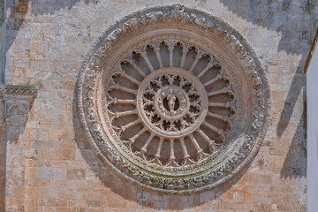 15th century rose window Ostuni Cathedral, Brindisi Province, Apulia, Italy.