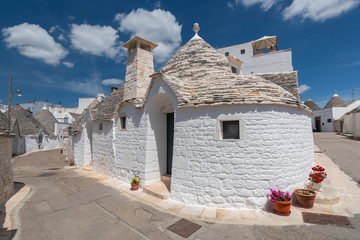 Unique Trulli houses, traditional Apulian dry stone hut with a conical roof in Alberobello, Puglia, Italy.