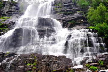 Scenic view of the falling water with stones