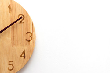 The concept close up of a clock the minute hand points to two number. White background with copy space.
