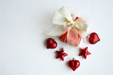 Red gift box. Bow of satin ribbon and Christmas decorations for the decor for the celebration of New year and Christmas.