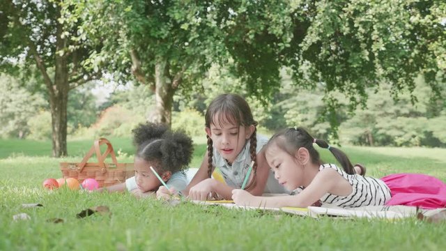 International children are drawing in park during school holidays.