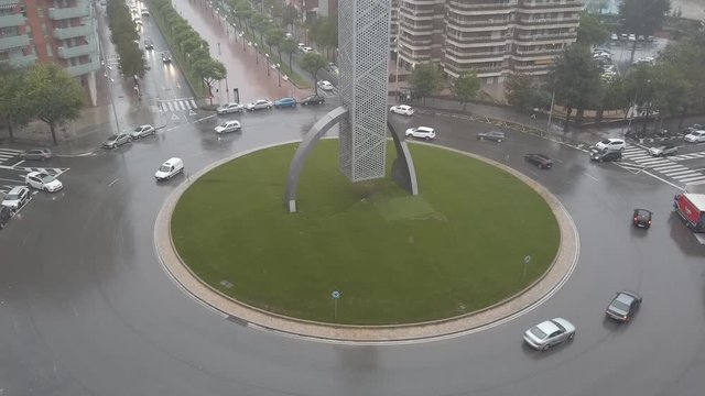 TARRAGONA, SPAIN-OCTOBER 22, 2019: Timelapse of cars going around the Torre dels Vents Tower in the Placa Corts Catalanes Traffic Circle in Tarragona, Spain.