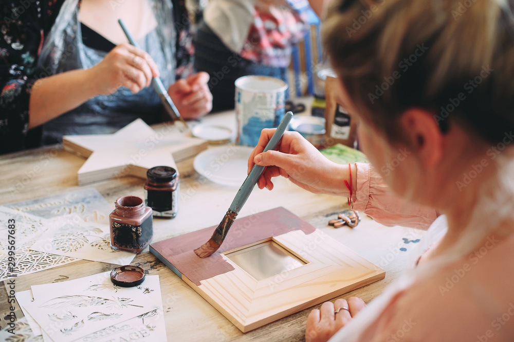 Wall mural master class on creativity. girl makes a frame