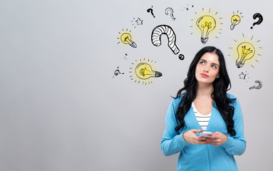 Question with light bulbs with thoughtful young woman holding a smartphone