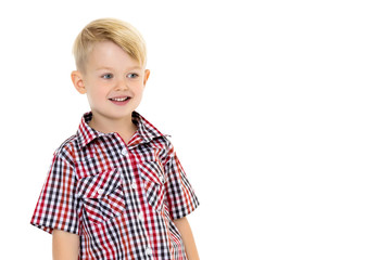 A cute little boy in a shirt and shorts.