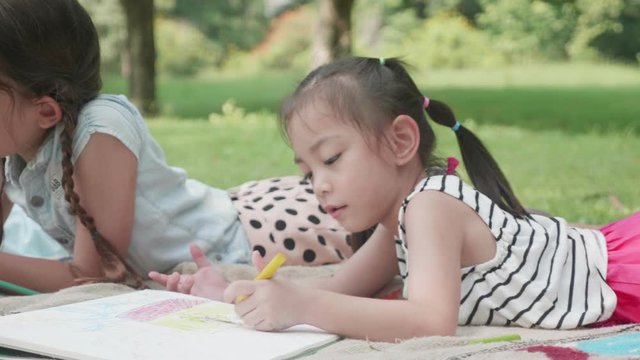 International children are drawing in park during school holidays.