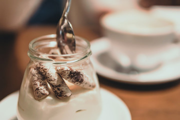 chocolate dessert in a glass jar on a wooden table