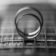 Two Wedding Rings on guitar strings. Shallow Depth Of Field