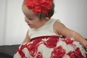 baby girl in a red roses dress