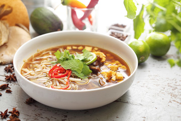 Oriental Vietnamese PHO soup with mint, coriander, tofu, caramelized oyster mushroom, lime, rice noodles and chilli pepper. Oriental Vietnamese soup