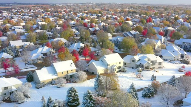 Beautiful neighborhoods, homes, Fall colors, at the magical point where Autumn meets Winter; first snow on Fall colors, colorful trees, aerial drone view.