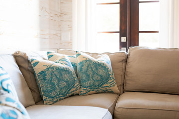 Cozy beach house living room with blue decorative pillows
