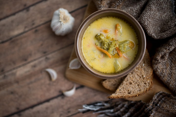 broccoli cheese soup served with toasted bread in a bowl