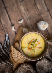 broccoli cheese soup served with toasted bread in a bowl