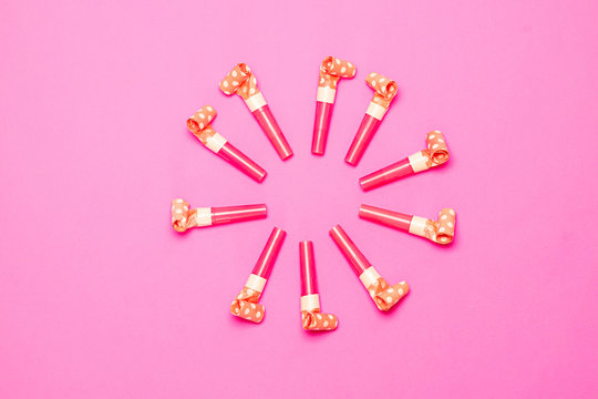 Party Blowers on pink background