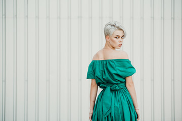 Emotional portrait of a beautiful blonde in green dress