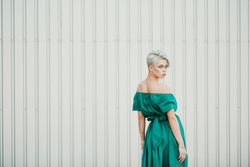 Emotional portrait of a beautiful blonde in green dress