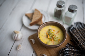 broccoli cheese soup served with toasted bread in a bowl