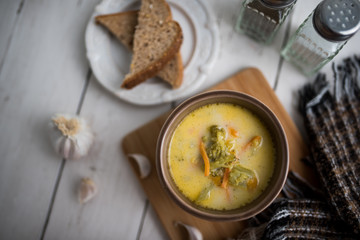 broccoli cheese soup served with toasted bread in a bowl