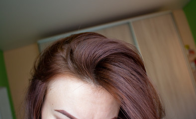 hair on a woman's head close-up. Hair brown color of.