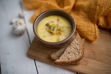 broccoli cheese soup served with toasted bread in a bowl
