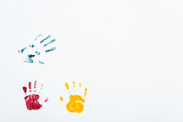 Fototapeta premium yellow, red and blue hand prints on white
