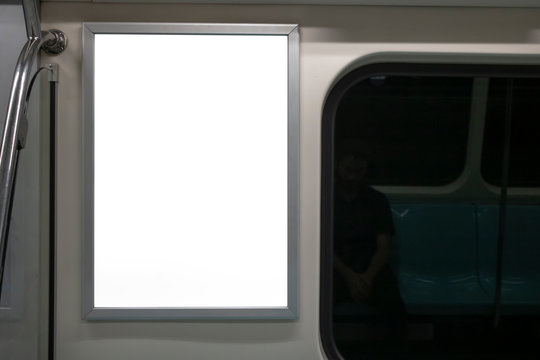 Blank advertising sign inside subway train. Close to the glass edge of the train.