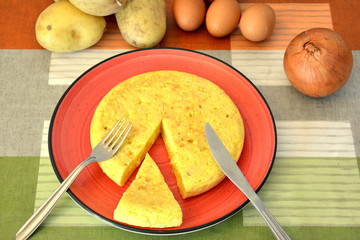 Spanish potato omelette on a geometric and colorful background. Tortilla de patatas