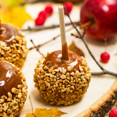 Caramel Apples on Wooden Background. Selective focus.