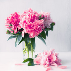 bouquet of pink peonies in a vase on the table. festive background with a bouquet of pink flowers.