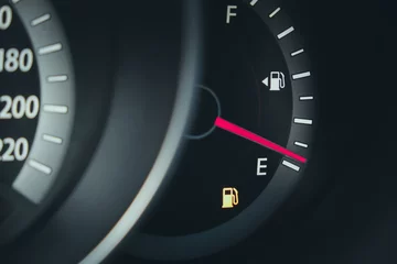 Fuel gauge with warning indicating low fuel tank © evgenius1985