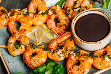Delicious roasted shrimps on plate with lemon