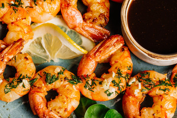 Delicious roasted shrimps on plate with lemon