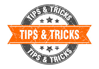 tips & tricks round stamp with orange ribbon. tips & tricks