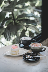 cup of coffee and cake on table
