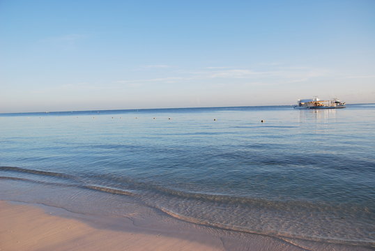 Pleasure and fishing ships are on the raid near the beach at sunset. Punta Cana, Dominican