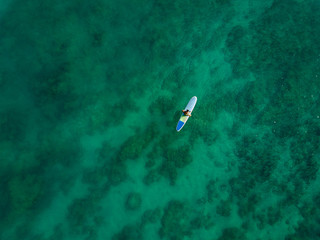 Aerial drone shot view of surfers in pacific ocean near Waikiki beach, Honolulu, Hawaii